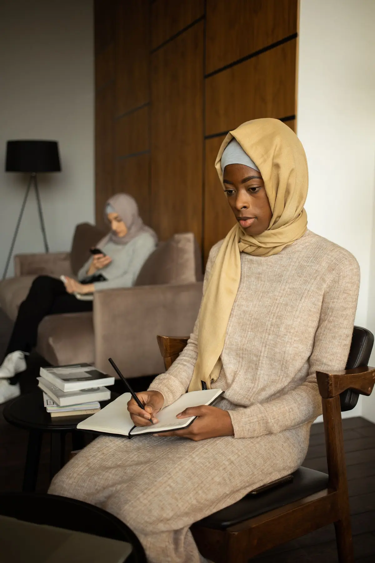 Woman writing in a notebook, studying at home